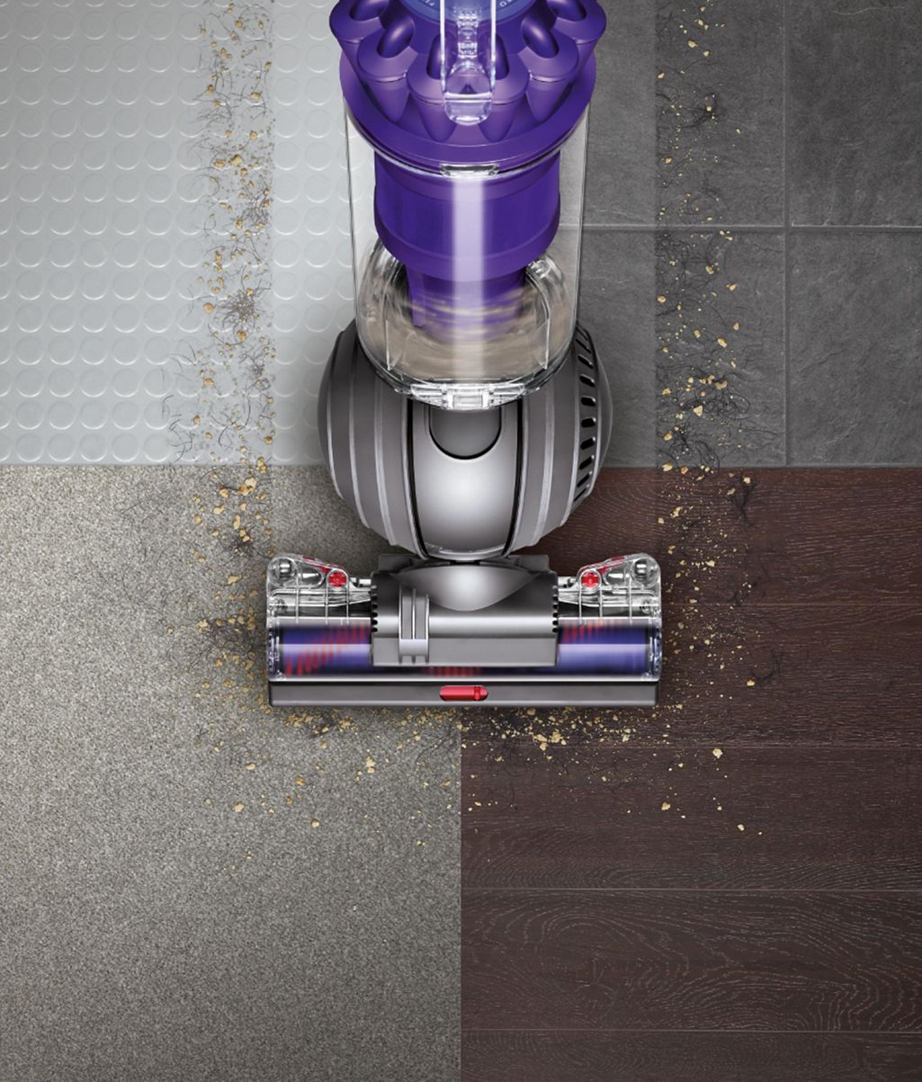 Dyson ball upright vacuum cleaner picking up debris across different floor  types