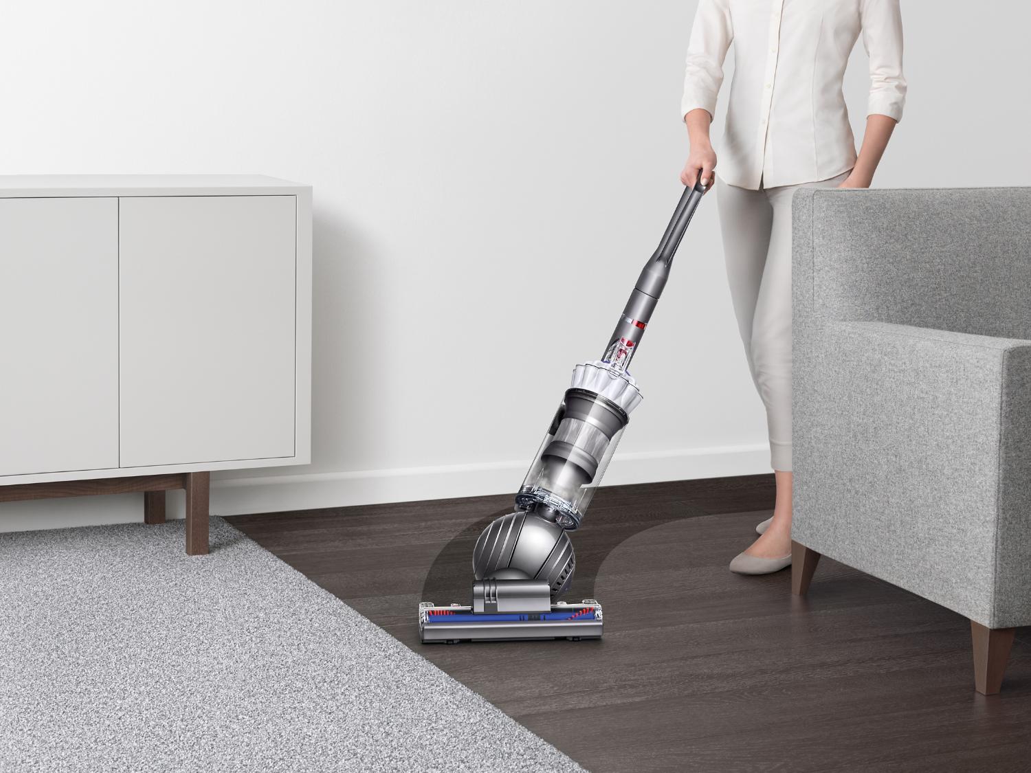 Woman pushing Dyson Slim Ball Multi Floor vacuum on hard floor