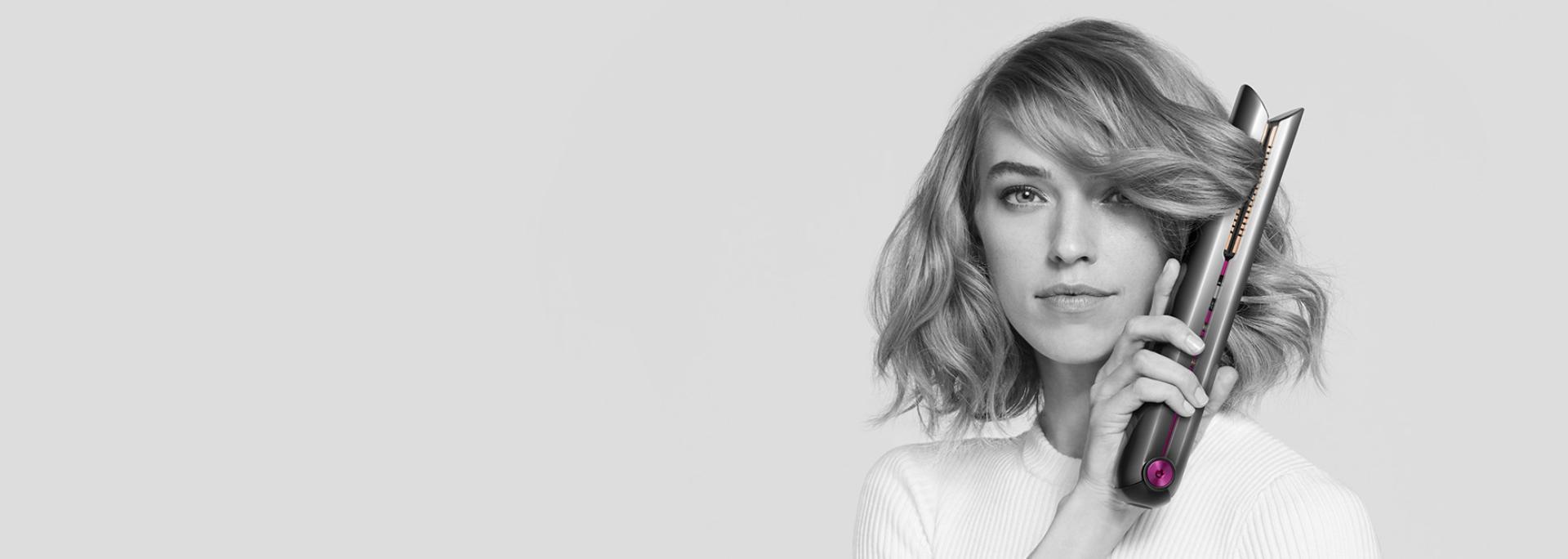 Model using the Dyson Corrale straightener