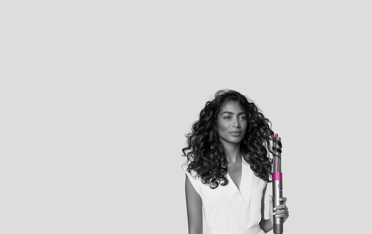 Woman curls her hair with Dyson Airwrap styler.