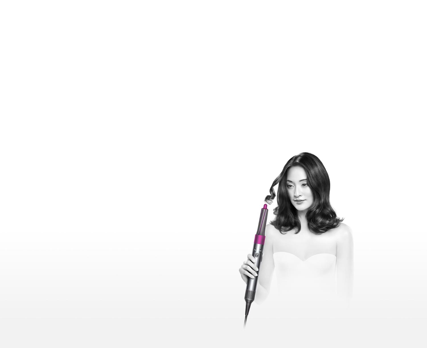 Model demonstrating the Dyson Airwrap™ hair styler to create bouncy curls