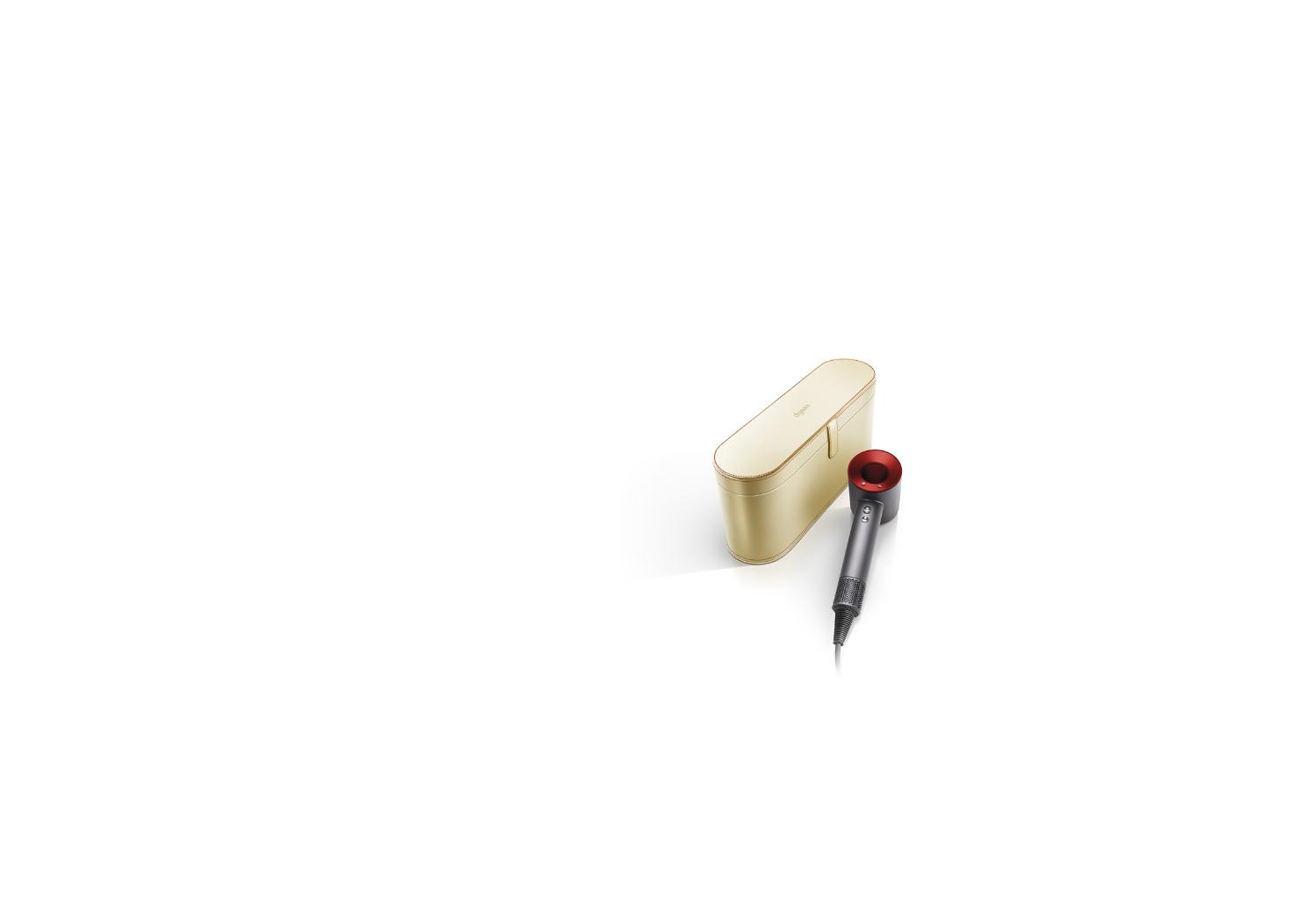 Gold presentation case displayed next to the Dyson Supersonic™