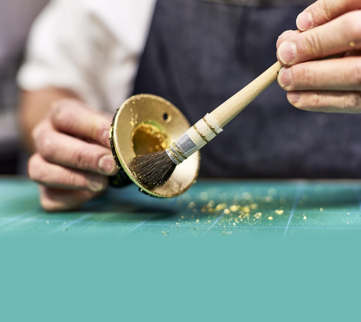 Dyson Supersonic™ hair dryer being hand gilded in gold leaf