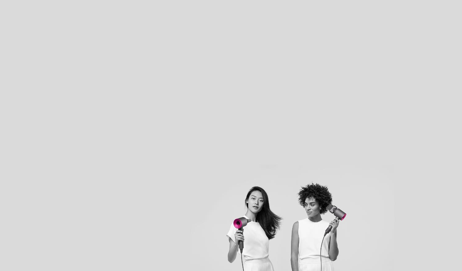2 models using Dyson Supersonicᵀᴹ with different attachments