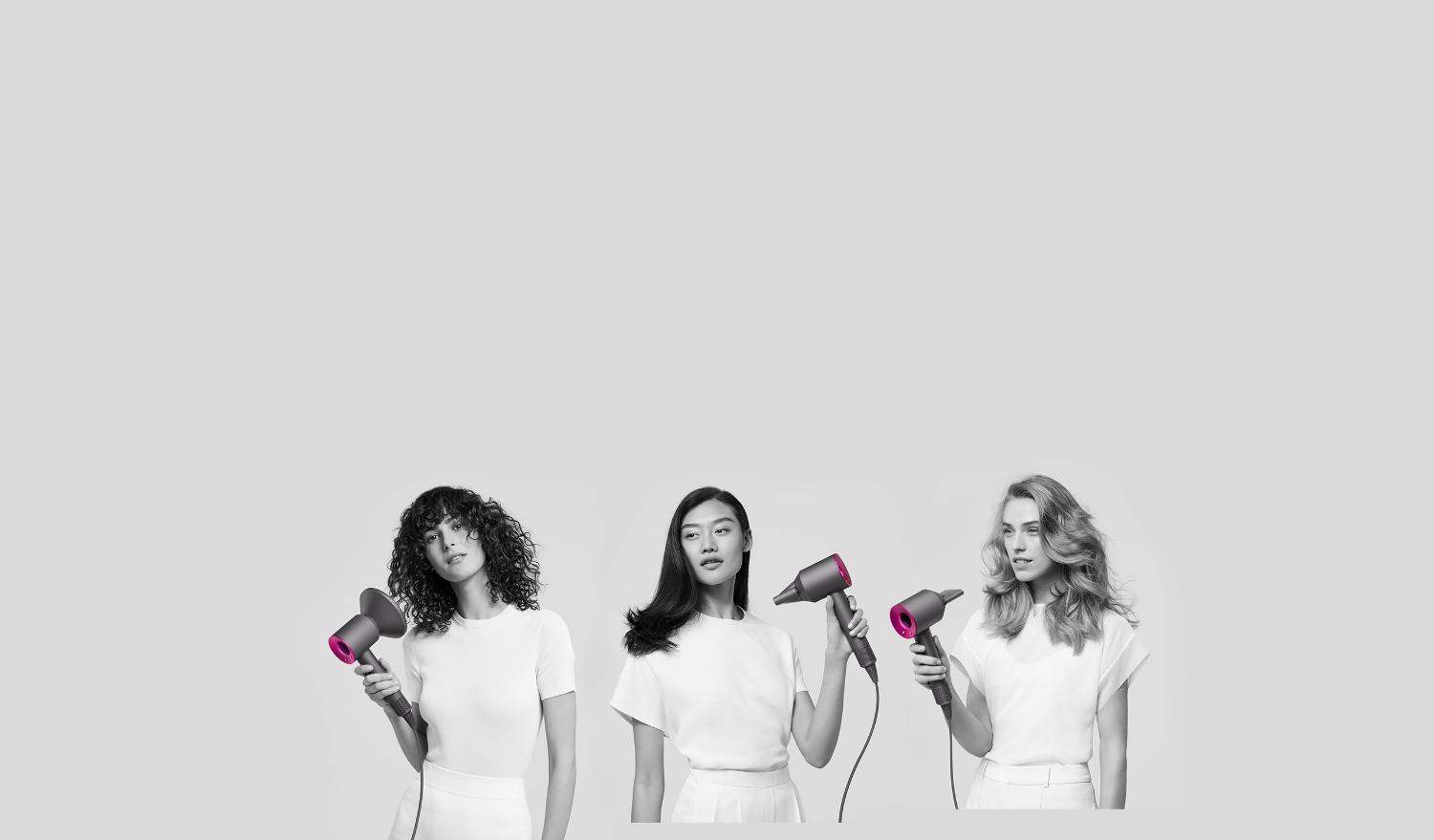 two models using Dyson Supersonic hair dryer