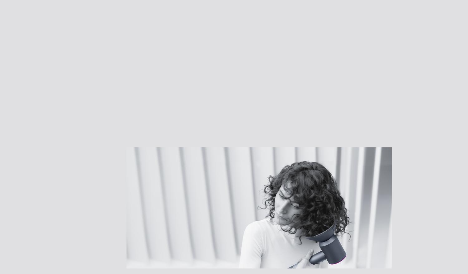 Woman drying her hair with the Dyson supersonic hair dryer