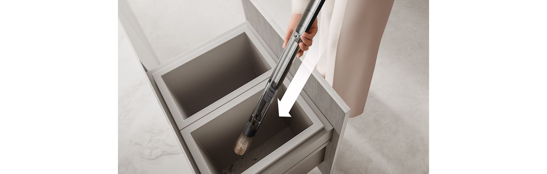 The Dyson PencilVac cleaner’s air-compression bin is emptied deep a household bin.