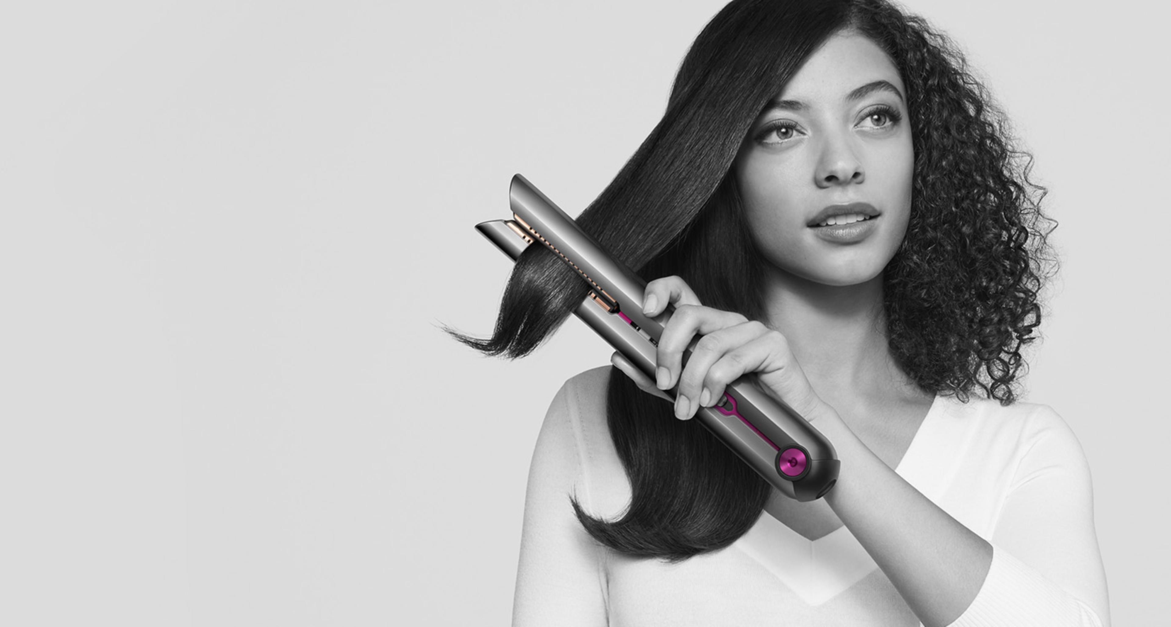 Woman straightening her hair with the Dyson Corrale straightener