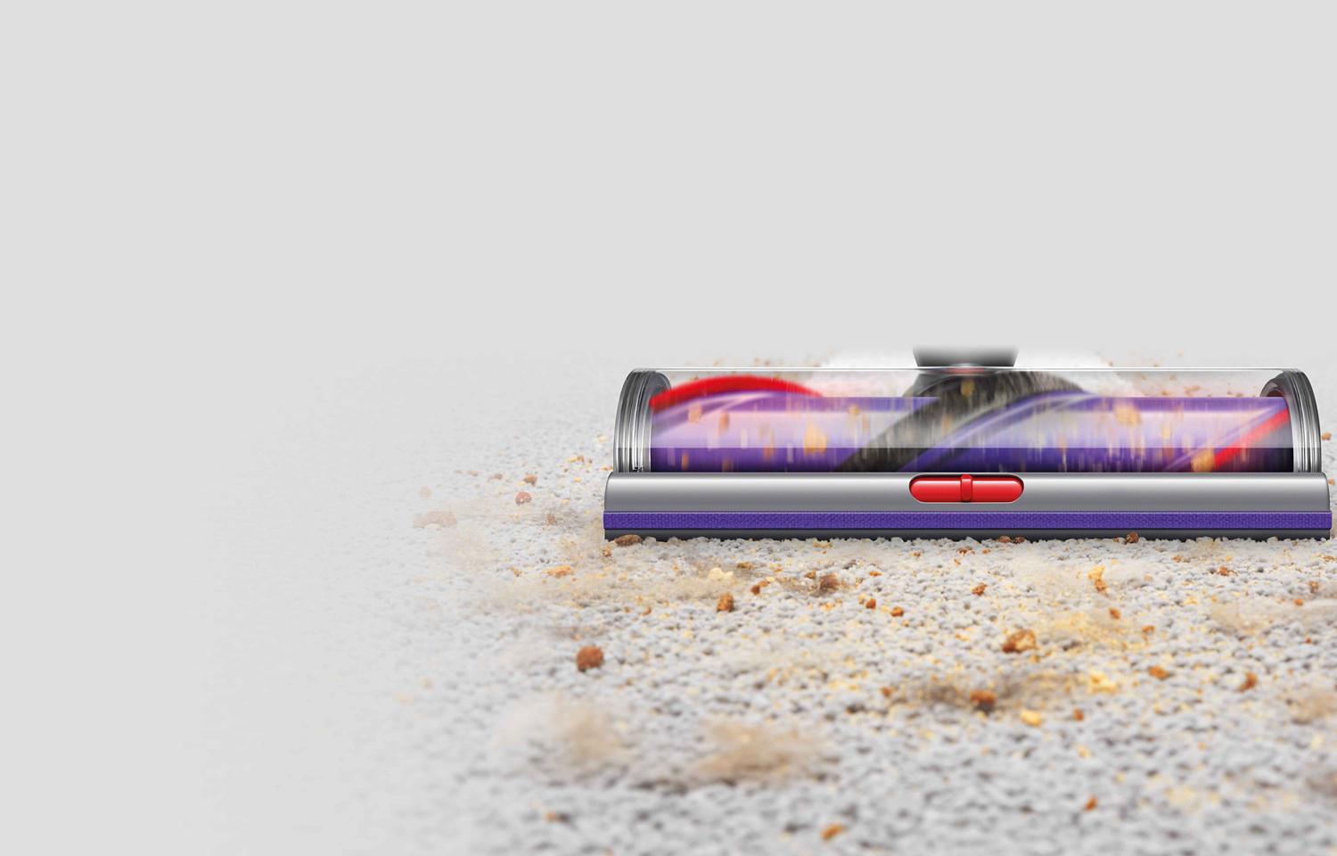Dyson vacuum cleaner head picking up debris from a carpet