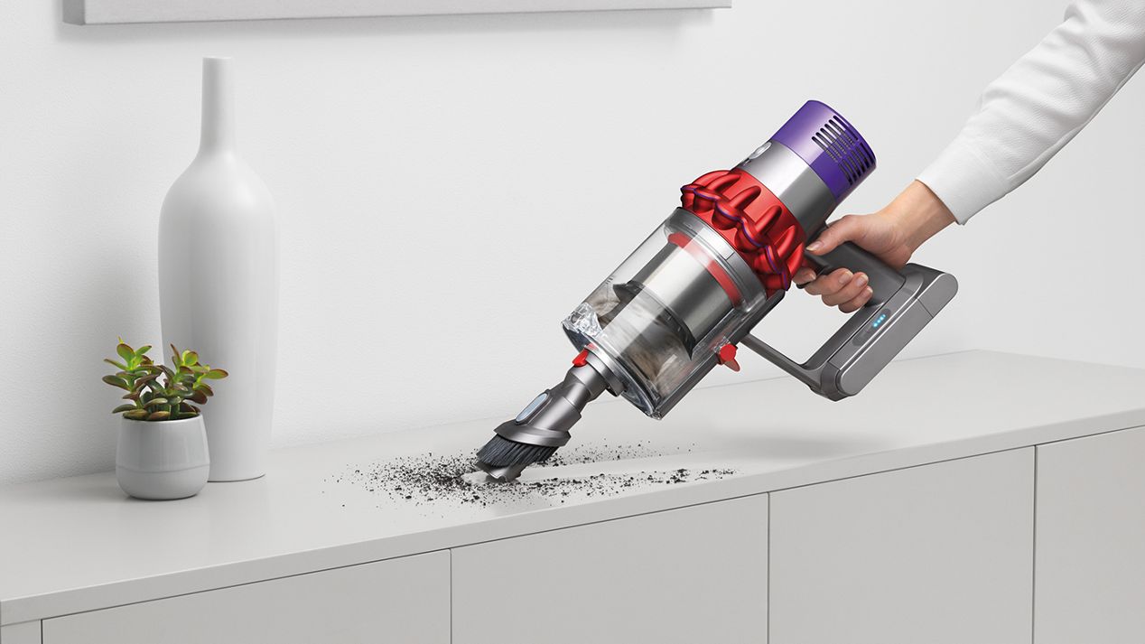 Dyson Cyclone V10™ vacuum in handheld mode cleaning furniture