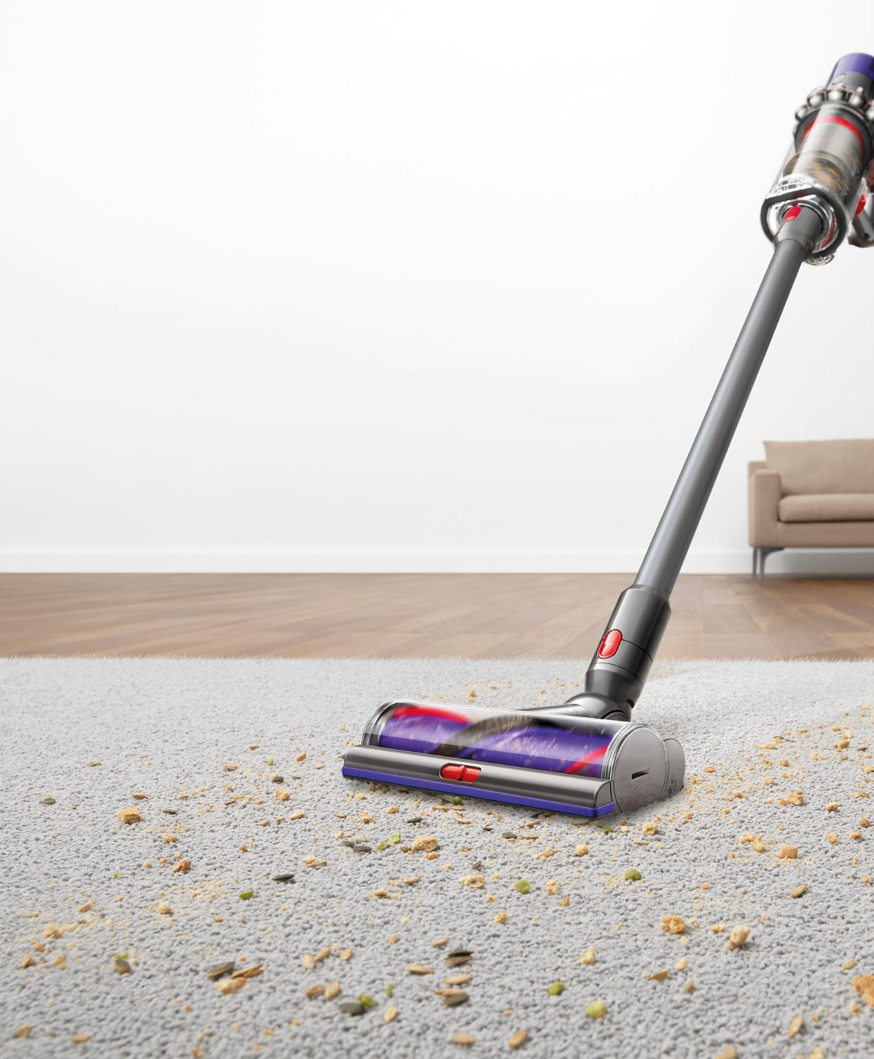Vacuum cleaner vacuuming pet food on carpet