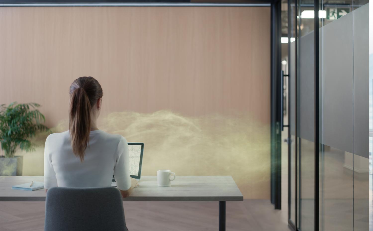 A woman in an office setting showing pollution in the air.