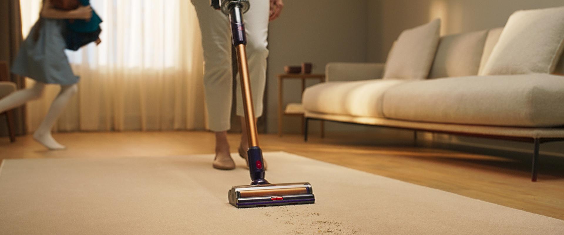 Dyson cordless stick vacuums cleaning around the home with laser