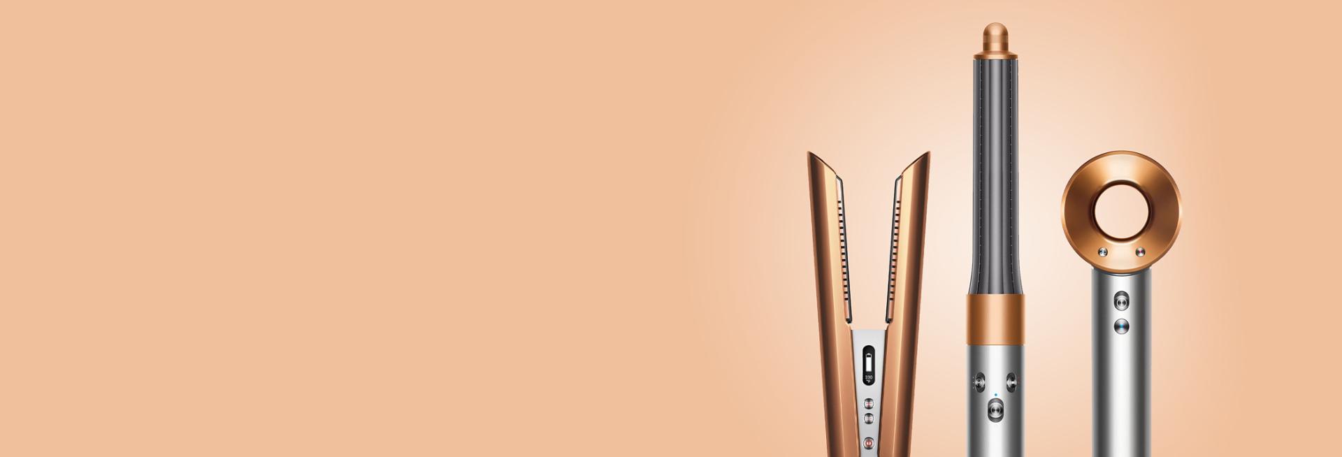 The Dyson hair care range in nickel copper on a peach background