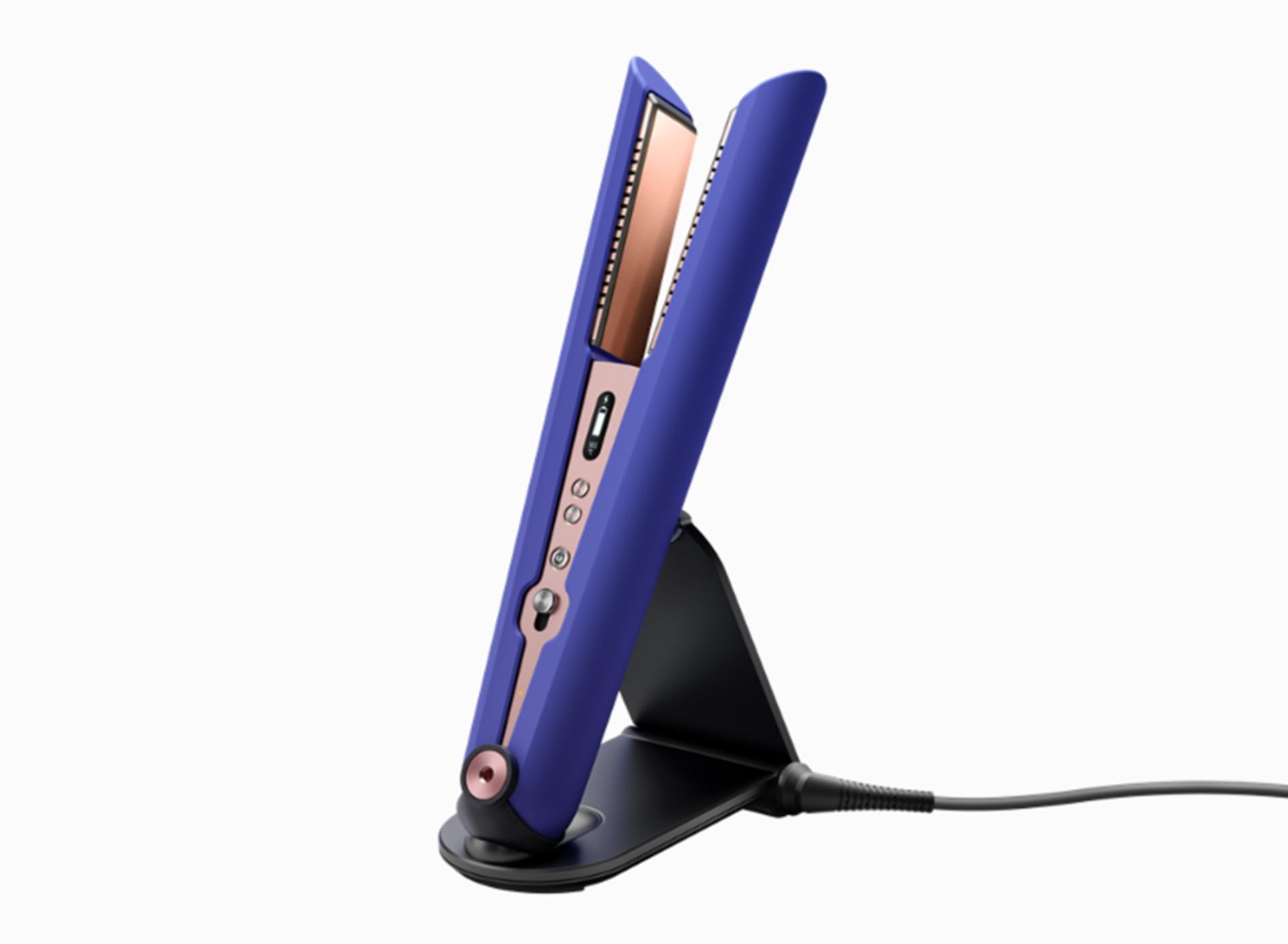 The Dyson Corrale straightener Vinca Blue & Rosé on travel stand