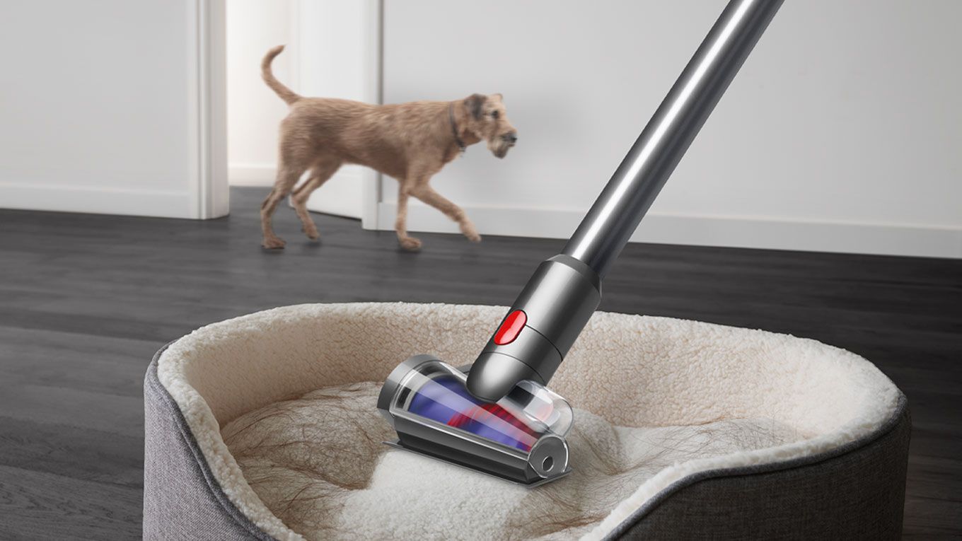 Hair screw tool cleaning pet hair off a pet bed