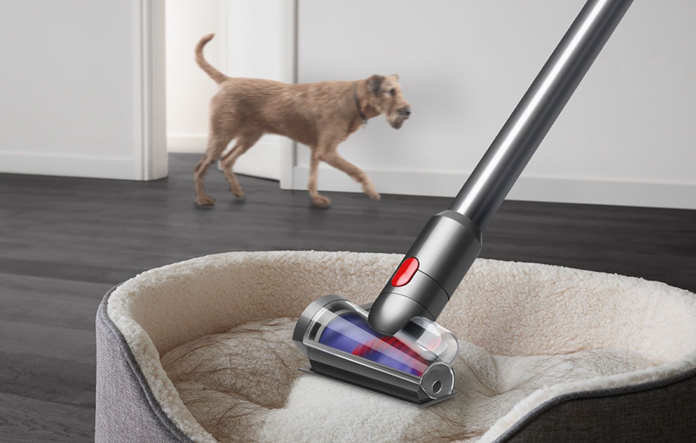 Hair screw tool cleaning pet hair off a pet bed