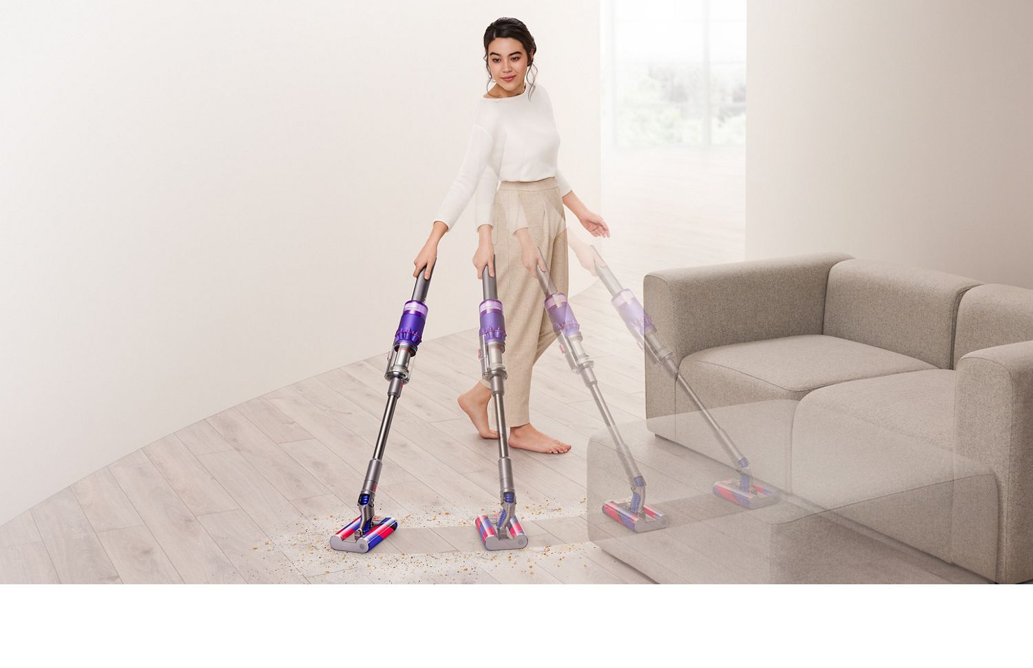 Woman using Dyson Omni-glide cordless vacuum.
