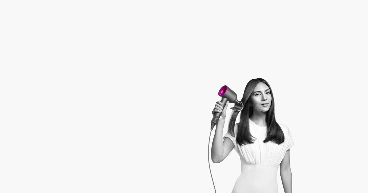 Model using a Dyson Supersonic hair dryer.