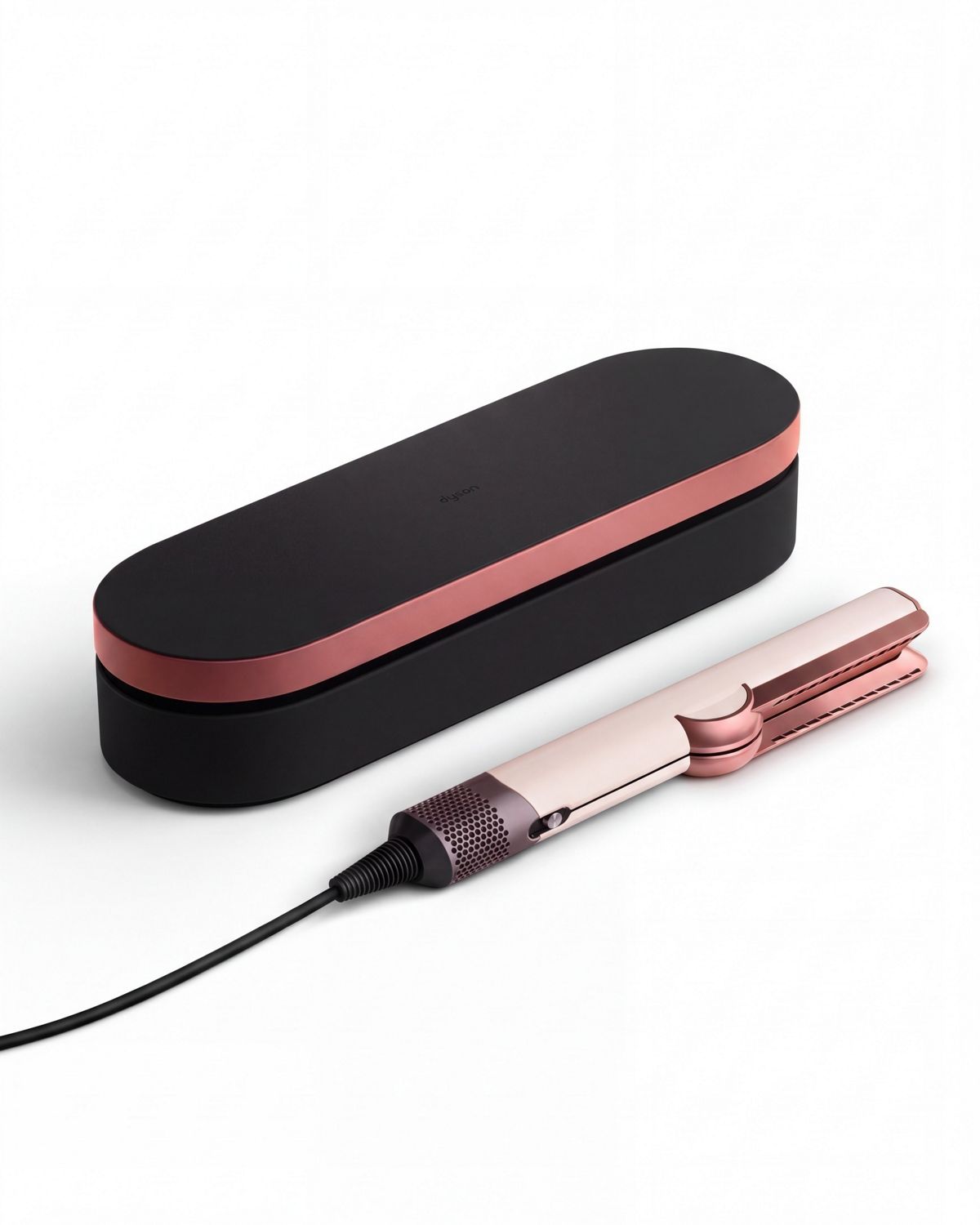 The Dyson Airstrait straightener in Ceramic Pink/Rose Gold shown beside a matching Presentation case.