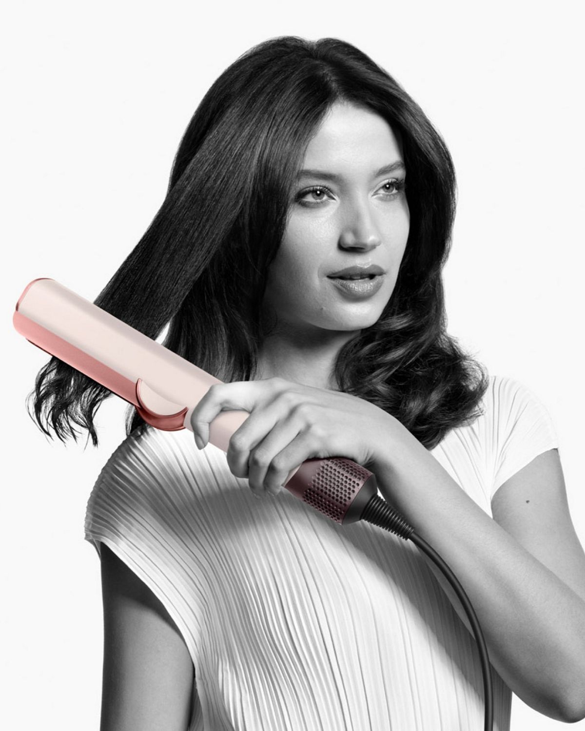 A model showing off her hair styled using the Dyson Airstrait straightener.