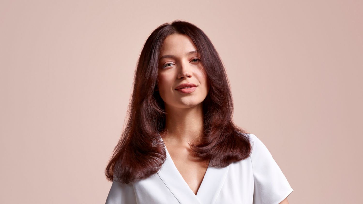A model showing off her hair styled using the Dyson Airstrait straightener.