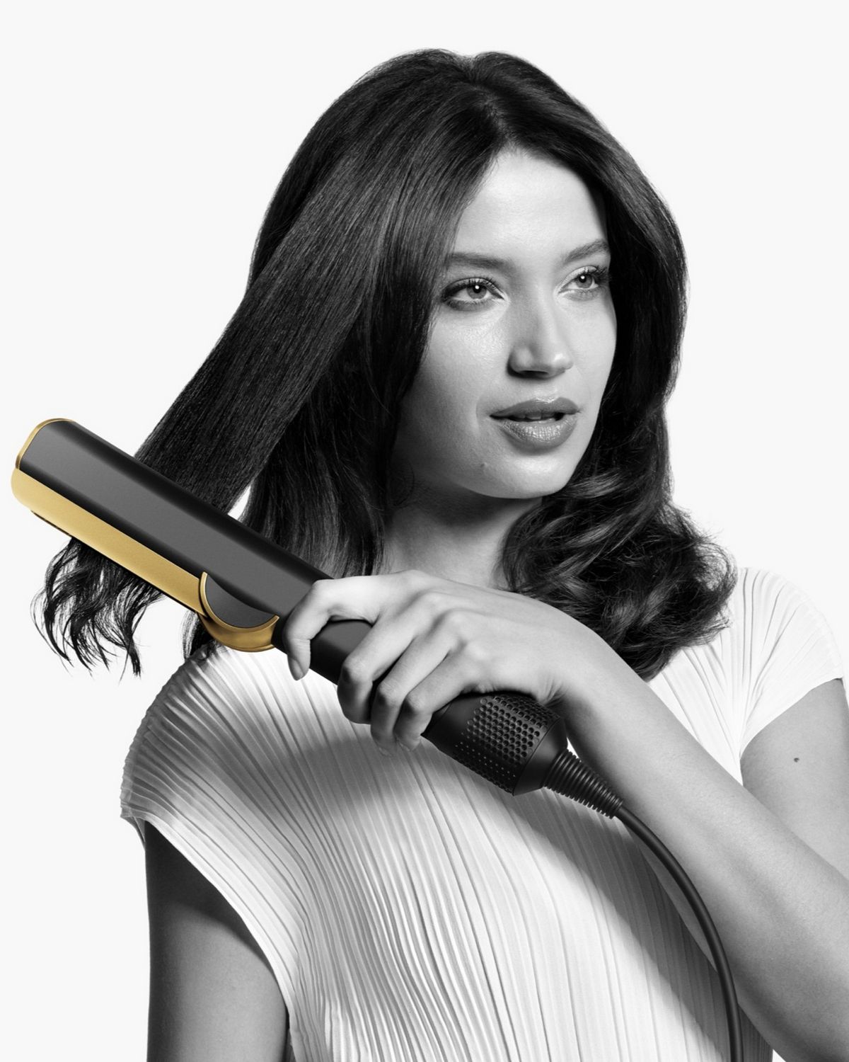 A model showing off her hair styled using the Dyson Airstrait straightener.