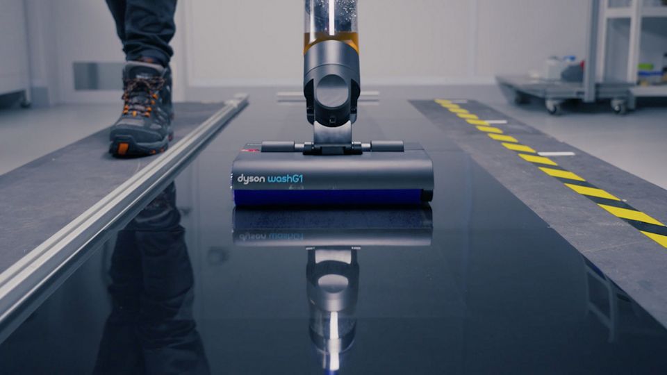 The Dyson WashG1 wet cleaner being tested on a sparkling floor