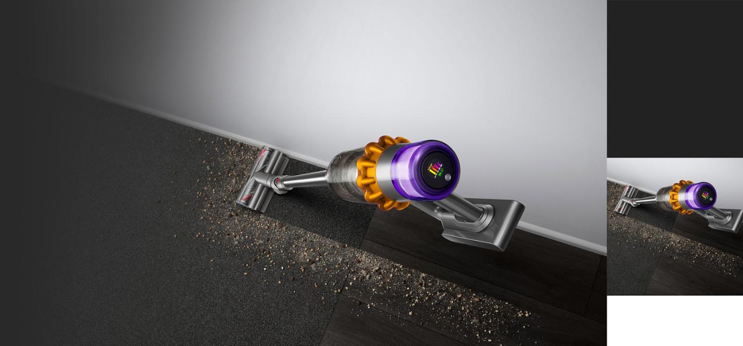Dyson V15 Detect cleaning from hard floor to carpet. The surface is covered in debris, and the V15 has left a completely clean path in its wake.