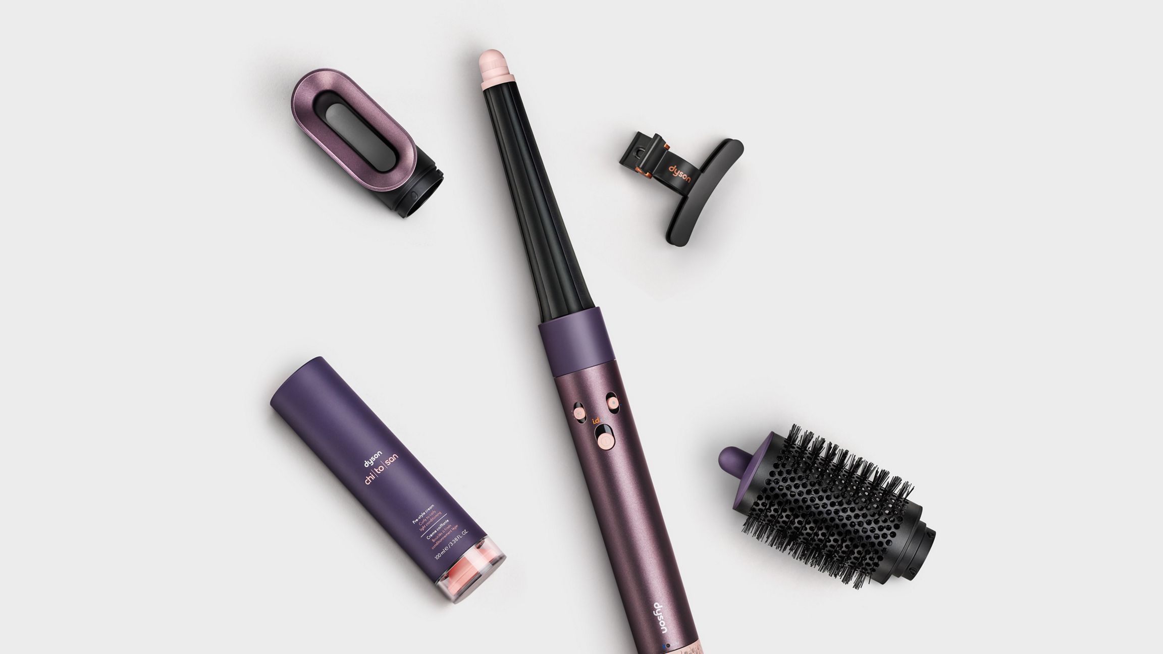 The Dyson Airwrap i.d. Straight + Wavy with all its attachments by its side.