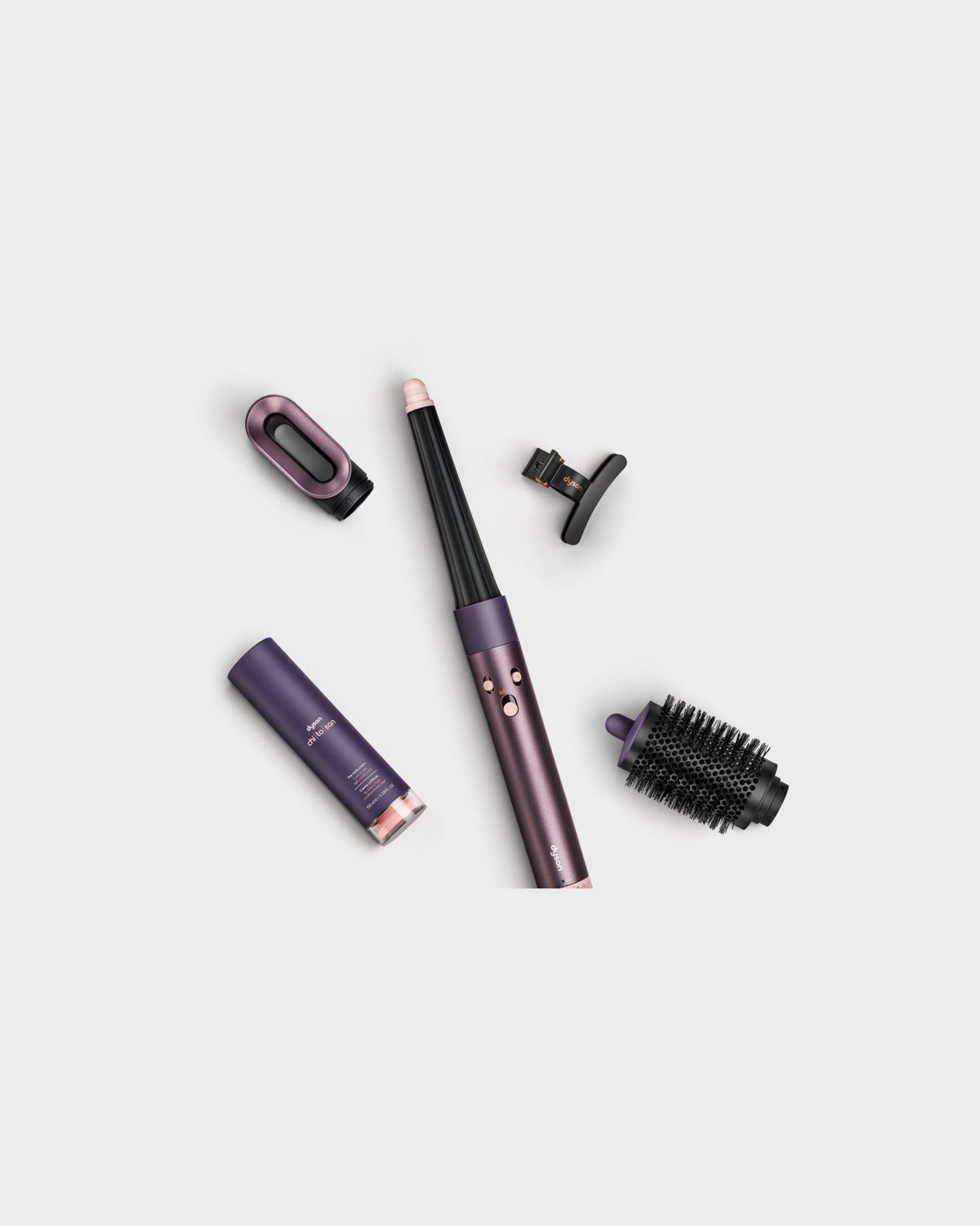 The Dyson Airwrap i.d. Curly + Coily with all its attachments by its side.