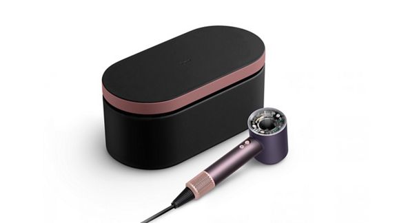 The Dyson Supersonic Nural hair dryer in Jasper plum shown beside a matching Presentation case.