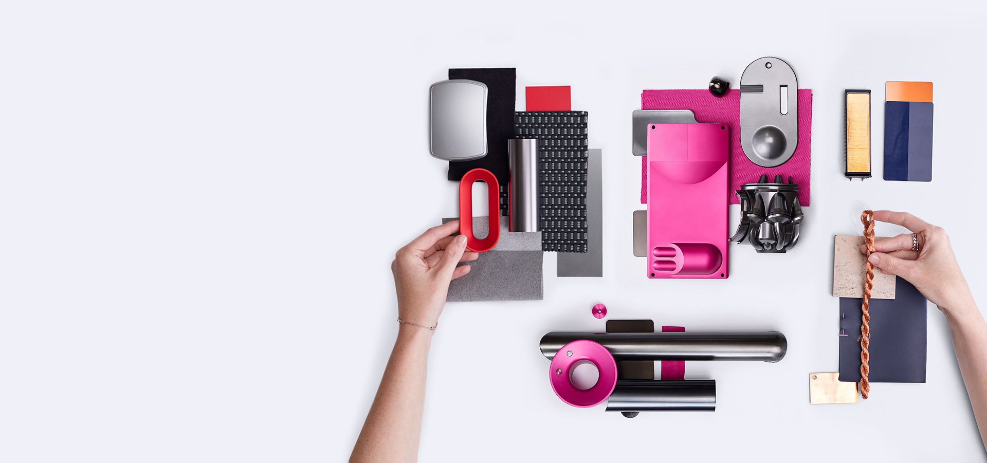 A selection of different materials and Dyson spare parts in vibrant colours.