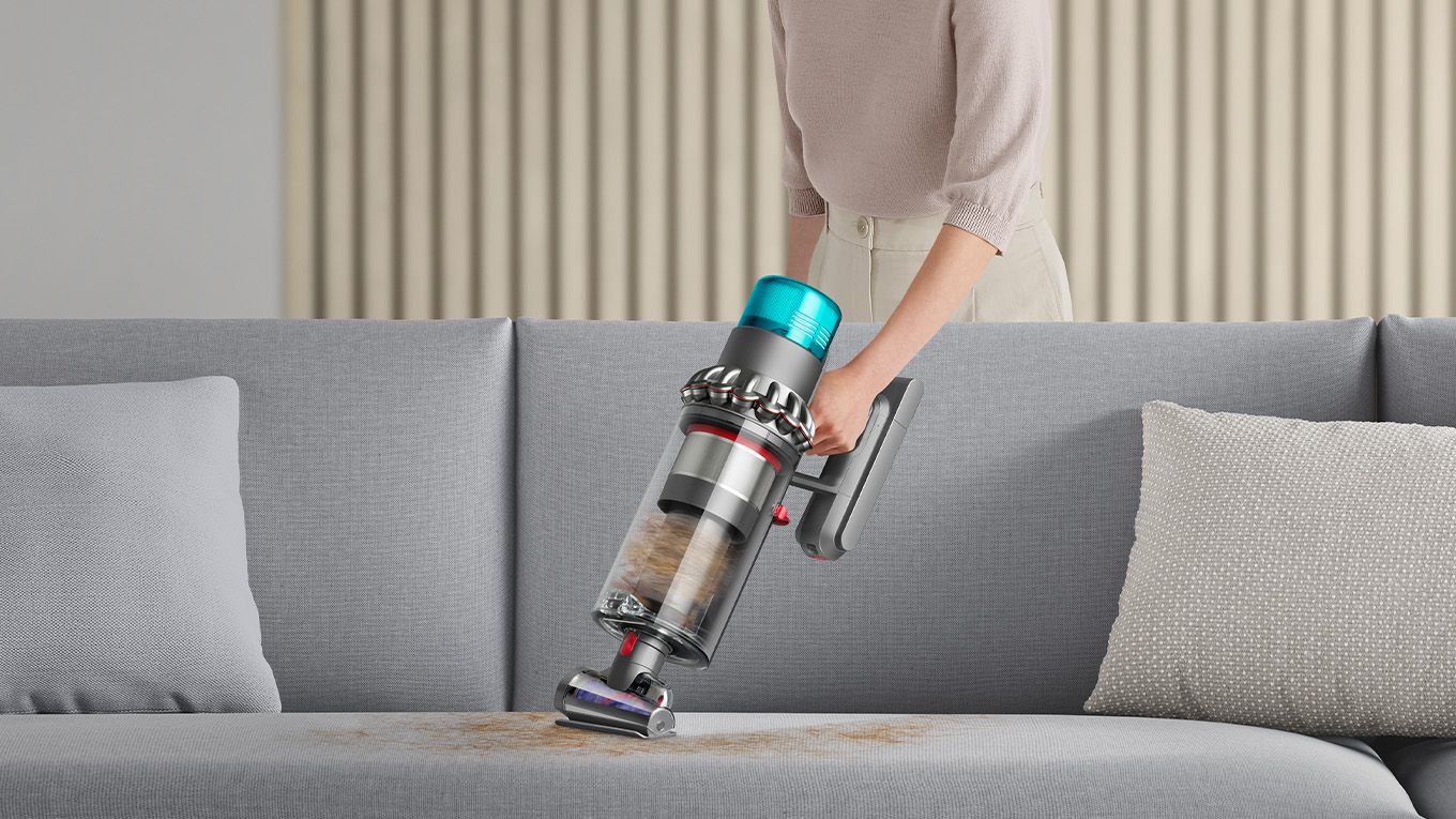 Dyson vacuum cleaner vacuuming pet hair off couch