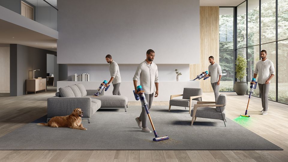 A person vacuuming after their pet in a living room area.