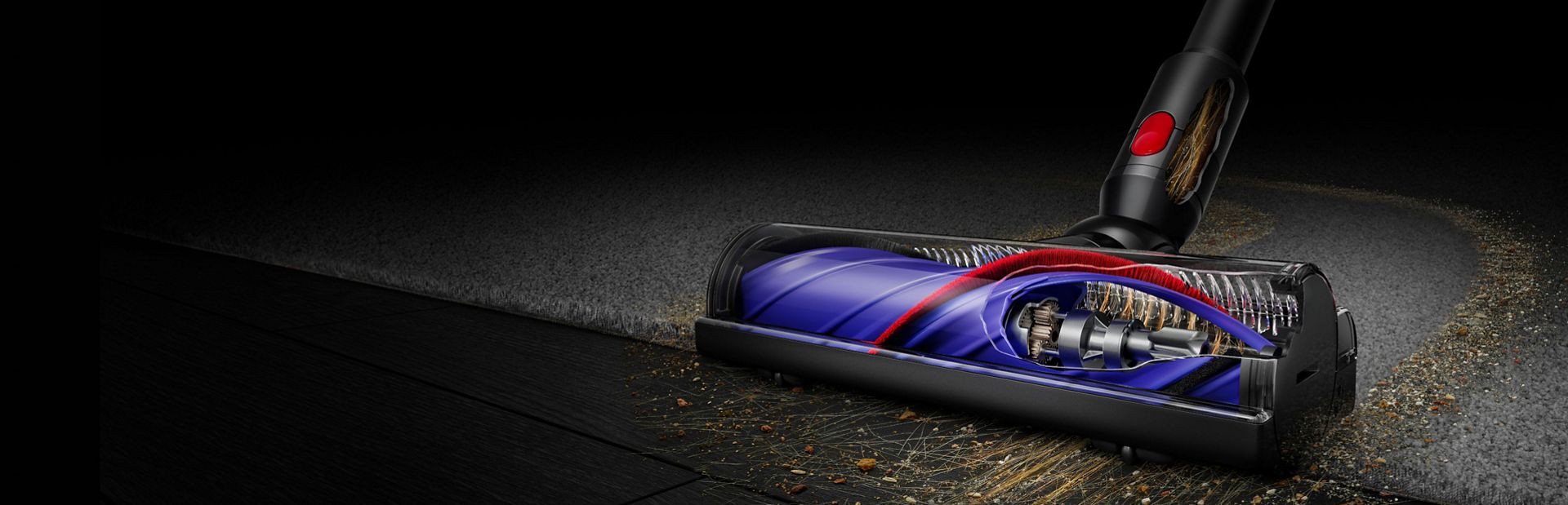 Dyson cleaner head clearing debris from a floor