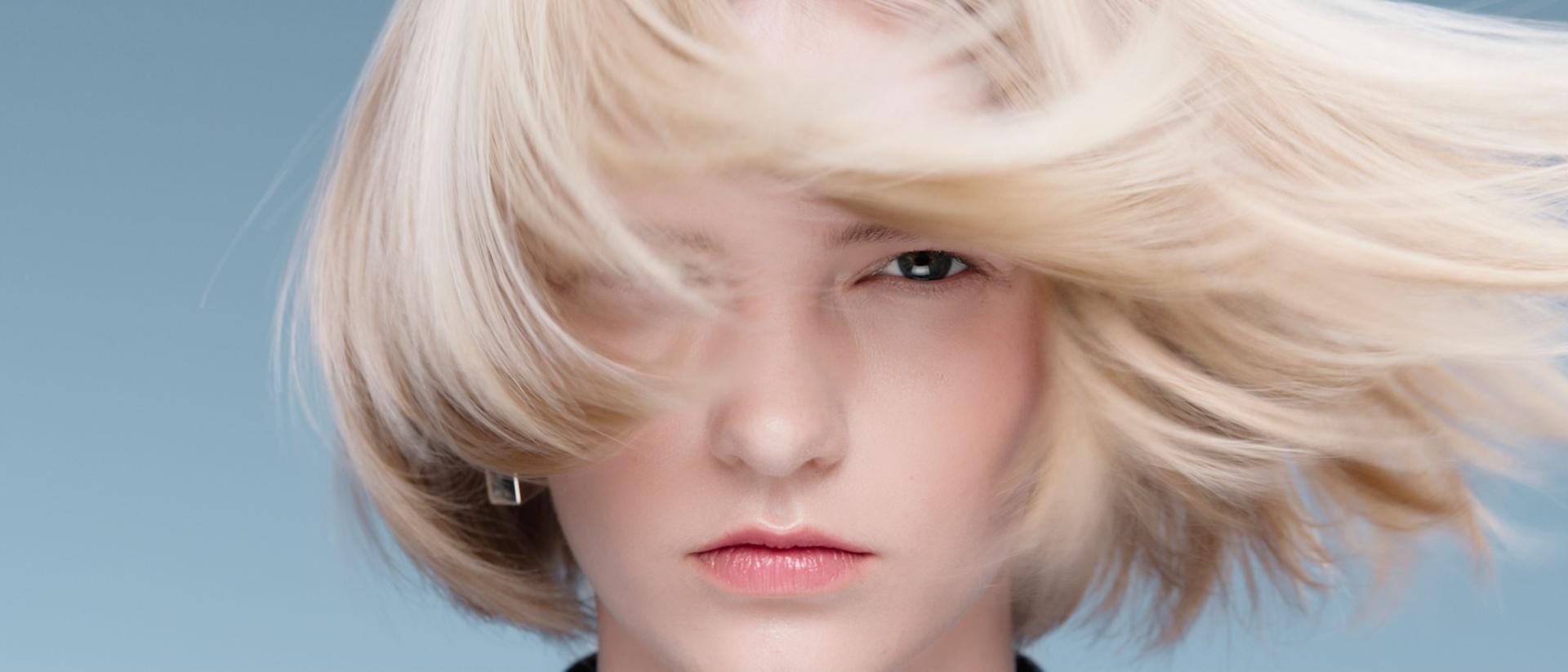 A model with elegantly styled hair achieved with Dyson Beauty devices and products.