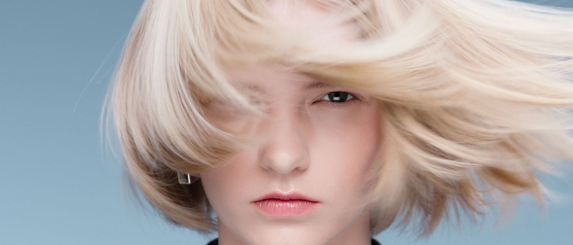 A model with elegantly styled hair achieved with Dyson Beauty devices and products.