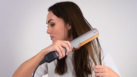 Dyson Supersonic hair dryer with Flyaway attachment used on hair