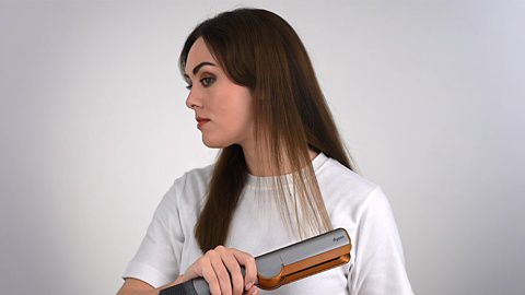 Dyson Supersonic hair dryer with Flyaway attachment used on hair
