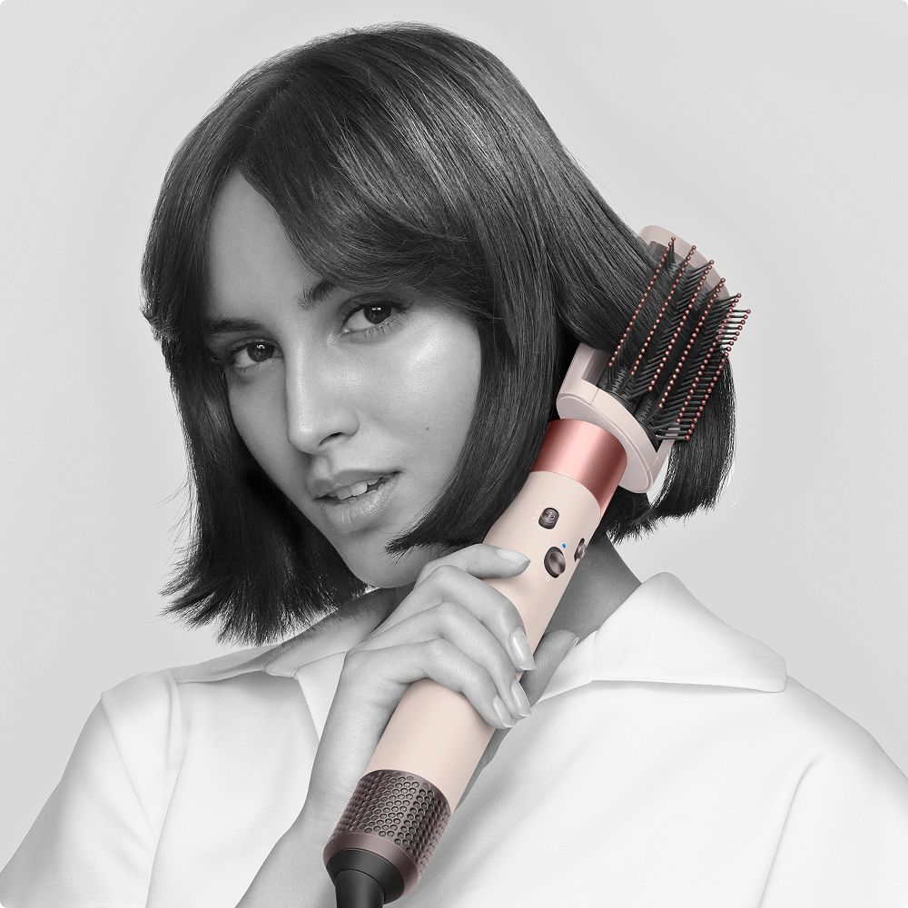 A model using the Dyson Airwrap to create a straighter, smoother style.