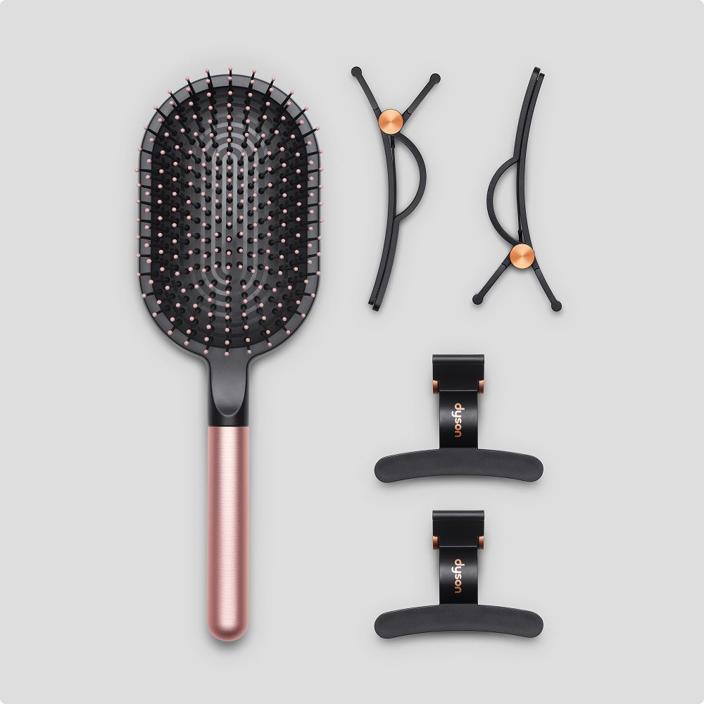 A paddle brush and set of four hair clips.