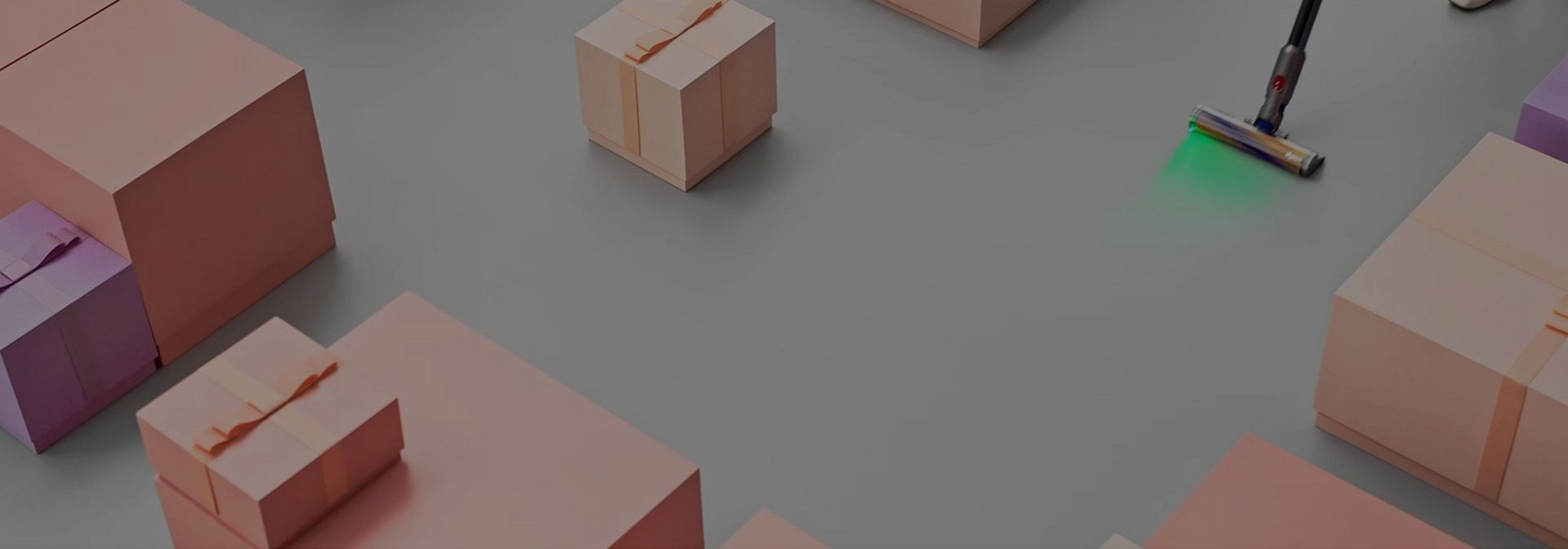A Dyson cordless vacuum cleans between a selection of gift-wrapped boxes.