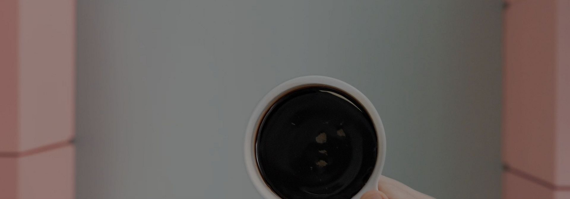 A cup holding freshly brewed coffee.