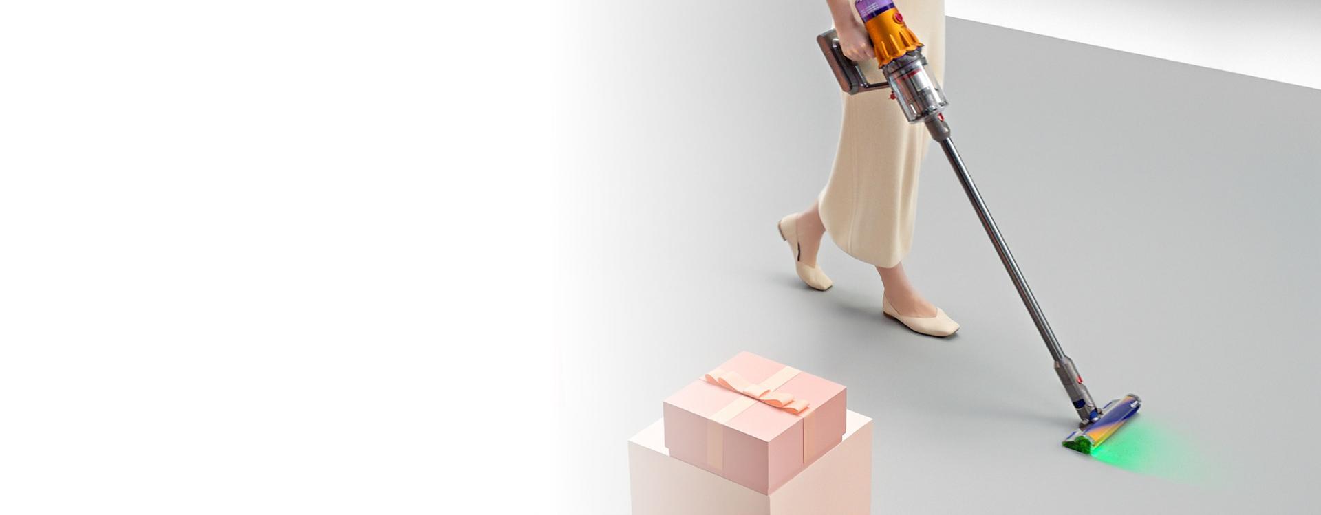 Dyson V12 Detect cordless vacuum used to clean dust and debris from a floor.