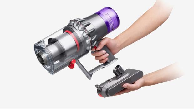A battery is clicked into place on a Dyson vacuum.