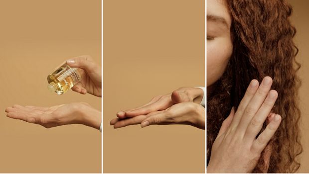 Olejek nawilżający do włosów Dyson Omega nakładany na dłoń i wcierany we włosy