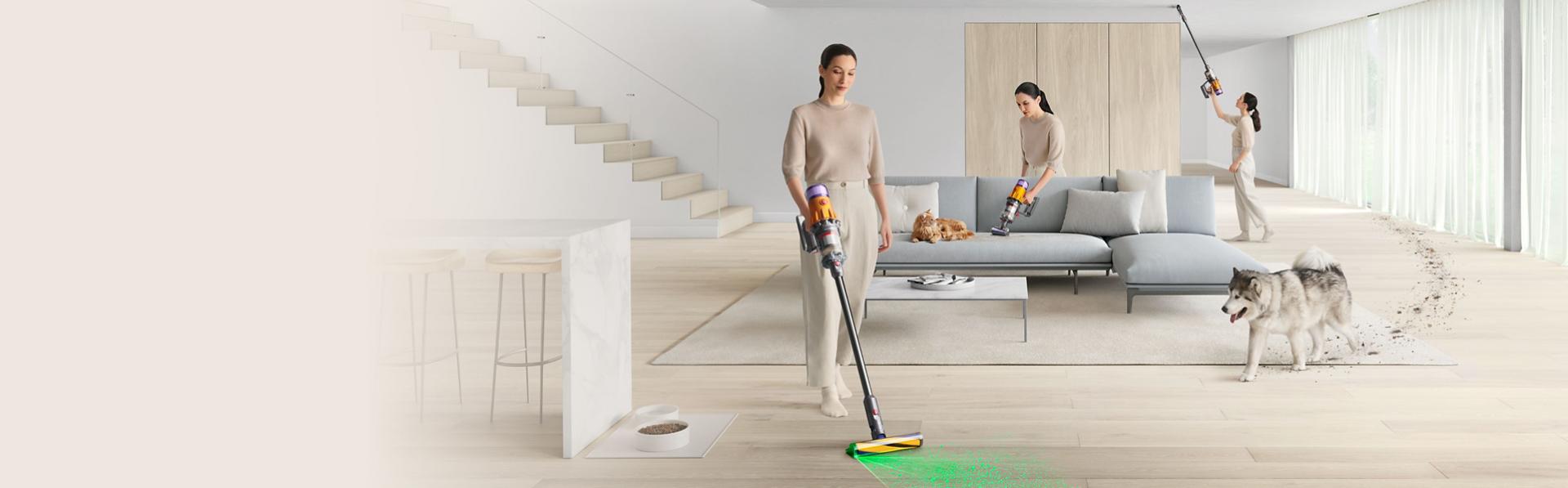 A person cleans around their home with a Dyson vacuum in stick and handheld modes.