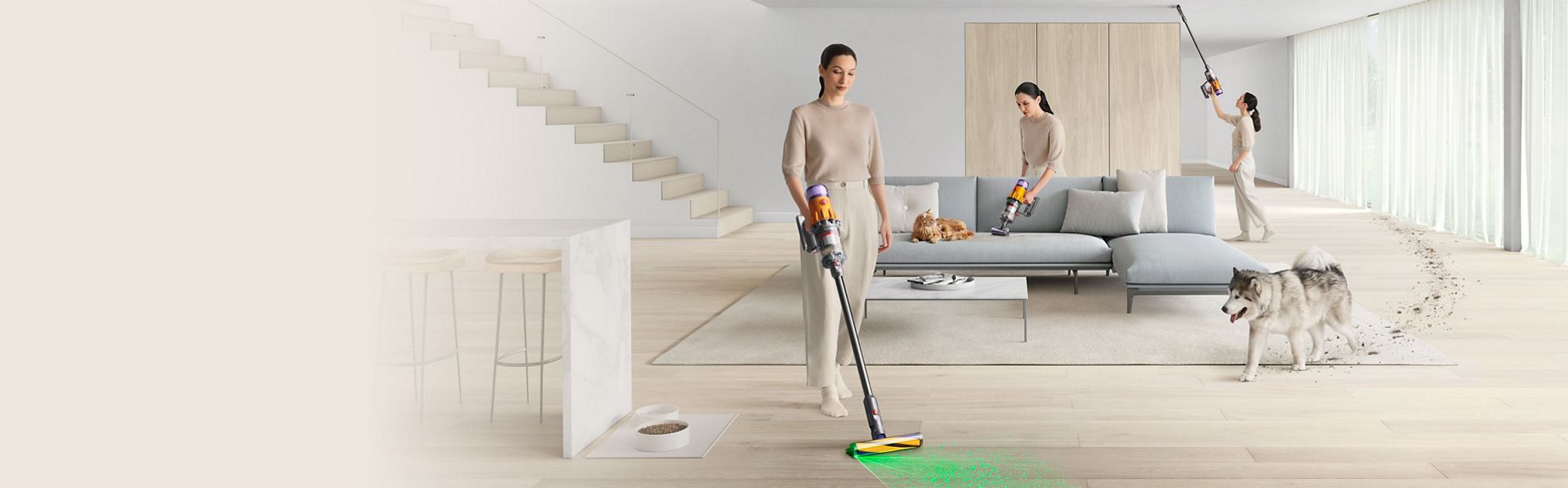 A person cleans around their home with a Dyson vacuum in stick and handheld modes.