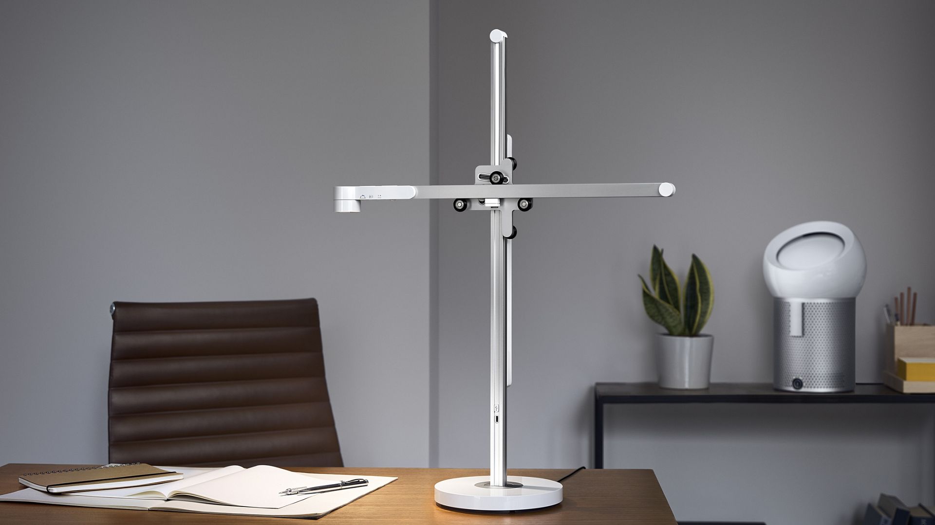 Home office with a Dyson Lightcycle task light and a Dyson Pure Cool Me purifying fan
